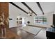 Bright living room showcasing ceiling beams, wood floors, and an open layout to the kitchen at 2524 E Elmwood St, Mesa, AZ 85213