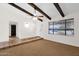 Open living room with exposed ceiling beams, tiled flooring, and ample natural light at 2524 E Elmwood St, Mesa, AZ 85213