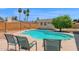 Enjoy backyard relaxation with this pool view featuring a seating area, shed, and privacy fence at 2524 E Elmwood St, Mesa, AZ 85213