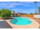 Inviting backyard featuring a sparkling pool, mature landscaping, and ample deck space for entertaining at 2524 E Elmwood St, Mesa, AZ 85213
