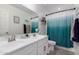 Bathroom featuring double vanity, a mirror and a turquoise ombre shower curtain at 26116 N Thornhill Dr, Peoria, AZ 85383