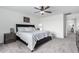 A primary bedroom featuring plush carpeting, a ceiling fan, neutral walls and a double dresser with a mirror at 26116 N Thornhill Dr, Peoria, AZ 85383