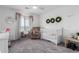 Cozy Bedroom with modern crib, and a comforting rocking chair with reading nook at 26116 N Thornhill Dr, Peoria, AZ 85383