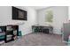 Bright bedroom featuring neutral walls, gray carpet, a dart board and two small study tables with storage shelves at 26116 N Thornhill Dr, Peoria, AZ 85383