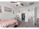 Well lit bedroom featuring a ceiling fan, decor, bed, small desk and walk-in closet at 26116 N Thornhill Dr, Peoria, AZ 85383