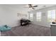A home bedroom with plush carpeting, white walls, a ceiling fan and a small piano at 26116 N Thornhill Dr, Peoria, AZ 85383