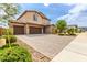 Stunning two-story home featuring a three-car garage and meticulously landscaped front yard at 26116 N Thornhill Dr, Peoria, AZ 85383