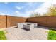Stylish stone firepit with built-in seating creates an ideal outdoor gathering spot at 26116 N Thornhill Dr, Peoria, AZ 85383