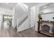 Bright and airy foyer featuring modern flooring, staircase, and stylish decor at 26116 N Thornhill Dr, Peoria, AZ 85383