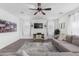 Cozy living room with a ceiling fan, comfortable seating, and natural light at 26116 N Thornhill Dr, Peoria, AZ 85383