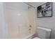 Tiled shower/tub combination featuring a shower curtain and abstract wall art at 2745 W Sunshine Butte Dr, San Tan Valley, AZ 85144