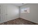 This bedroom features wood-look floors and a bright window overlooking the community at 2745 W Sunshine Butte Dr, San Tan Valley, AZ 85144