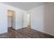 Bedroom features wood-look floors, closet, and easy access to bathroom at 2745 W Sunshine Butte Dr, San Tan Valley, AZ 85144