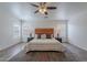 Cozy bedroom featuring an inviting bed, bedside tables with lamps, and wood-look floors for added warmth at 2745 W Sunshine Butte Dr, San Tan Valley, AZ 85144