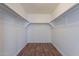 Walk-in closet featuring wood-look floors and double hanging rods for optimal storage at 2745 W Sunshine Butte Dr, San Tan Valley, AZ 85144