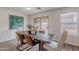 Cozy dining room features a rustic wood table, leather chairs, and sliding glass doors to the backyard at 2745 W Sunshine Butte Dr, San Tan Valley, AZ 85144
