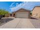 Single-story home featuring a two-car garage and desert landscaping under a blue sky at 2745 W Sunshine Butte Dr, San Tan Valley, AZ 85144