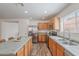 Bright kitchen features stainless steel appliances, wood cabinets, and an extended island with seating at 2745 W Sunshine Butte Dr, San Tan Valley, AZ 85144