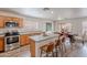 Bright kitchen featuring stainless steel appliances, an island with seating, and open floor plan at 2745 W Sunshine Butte Dr, San Tan Valley, AZ 85144