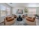 Well-lit living room with hardwood floors, modern decor, and comfortable seating exudes a cozy ambiance at 2745 W Sunshine Butte Dr, San Tan Valley, AZ 85144