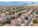 Elevated perspective of a community featuring diverse homes, lush greenery, and scenic mountains at 2745 W Sunshine Butte Dr, San Tan Valley, AZ 85144