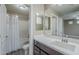 Well-lit bathroom featuring a shower-tub combo and a vanity with dark wood cabinets and a large mirror at 2821 S Skyline Dr # 149, Mesa, AZ 85212