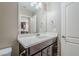 Bathroom with a dark wood vanity, white countertop, and a framed mirror reflecting the neutral wall color at 2821 S Skyline Dr # 149, Mesa, AZ 85212