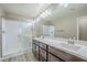 Bathroom with a glass-enclosed shower and a double sink vanity featuring dark wood cabinets at 2821 S Skyline Dr # 149, Mesa, AZ 85212