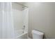 Close-up of a well-lit bathtub and toilet with white tile surround and neutral-colored walls at 2821 S Skyline Dr # 149, Mesa, AZ 85212