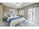 Comfortable bedroom with an exterior patio door, natural light, soft blues, and a queen-sized bed at 2821 S Skyline Dr # 149, Mesa, AZ 85212
