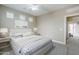 Neutral bedroom with soft carpet, three windows, ceiling fan and view into hallway at 2821 S Skyline Dr # 149, Mesa, AZ 85212