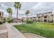 Landscaped walking path through the community with a view of the pool and multi-story homes at 2821 S Skyline Dr # 149, Mesa, AZ 85212