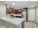 Modern kitchen featuring stainless steel appliances, a quartz countertop, and rich wood cabinets at 2821 S Skyline Dr # 149, Mesa, AZ 85212