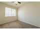 This simple bedroom has a window letting in lots of natural light and neutral walls at 29870 W Weldon Ave, Buckeye, AZ 85396