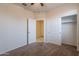 This is a simple bedroom with neutral colored walls and a view into the closet at 29870 W Weldon Ave, Buckeye, AZ 85396