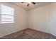 This bedroom contains neutral colored walls and a large window at 29870 W Weldon Ave, Buckeye, AZ 85396