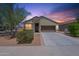 Inviting single-story home featuring a two-car garage, desert landscaping, and a stone facade at 29870 W Weldon Ave, Buckeye, AZ 85396