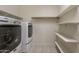 This laundry room has a washer and dryer set with shelving for storage at 29870 W Weldon Ave, Buckeye, AZ 85396