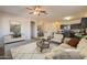 Open-concept living room flows into the dining area and kitchen with neutral tones and modern decor at 29870 W Weldon Ave, Buckeye, AZ 85396