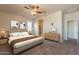Serene main bedroom with neutral walls, a ceiling fan, and a view of the walk-in closet at 29870 W Weldon Ave, Buckeye, AZ 85396