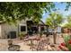 Spacious backyard with a pergola, hot tub, patio furniture, desert landscaping, and decorative statues at 29915 N Maravilla Dr, San Tan Valley, AZ 85143