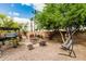 Well-kept backyard featuring a pergola, hot tub, patio set, desert landscaping and a hammock chair at 29915 N Maravilla Dr, San Tan Valley, AZ 85143