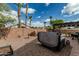 Enclosed backyard featuring a hot tub, lush greenery, and a charming patio area, ideal for relaxing and entertaining at 29915 N Maravilla Dr, San Tan Valley, AZ 85143