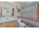 Bathroom featuring a single sink vanity, toilet, and shower with colorful curtain at 29915 N Maravilla Dr, San Tan Valley, AZ 85143