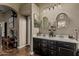 Bathroom featuring a double sink vanity with round mirrors and modern lighting at 29915 N Maravilla Dr, San Tan Valley, AZ 85143