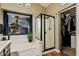 Bathroom with a soaking tub, shower, and walk-in closet at 29915 N Maravilla Dr, San Tan Valley, AZ 85143
