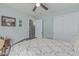 Bedroom with a ceiling fan, wood floors, closet with double doors, and adjoining bathroom at 29915 N Maravilla Dr, San Tan Valley, AZ 85143