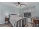 Cozy bedroom with a ceiling fan, a bed with floral patterned bedding, and a window at 29915 N Maravilla Dr, San Tan Valley, AZ 85143