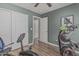 Exercise room featuring workout equipment, two closets, laminate flooring, and neutral colored walls at 29915 N Maravilla Dr, San Tan Valley, AZ 85143