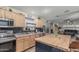 Modern kitchen features wood cabinets, stainless appliances, breakfast bar, and contemporary backsplash at 29915 N Maravilla Dr, San Tan Valley, AZ 85143